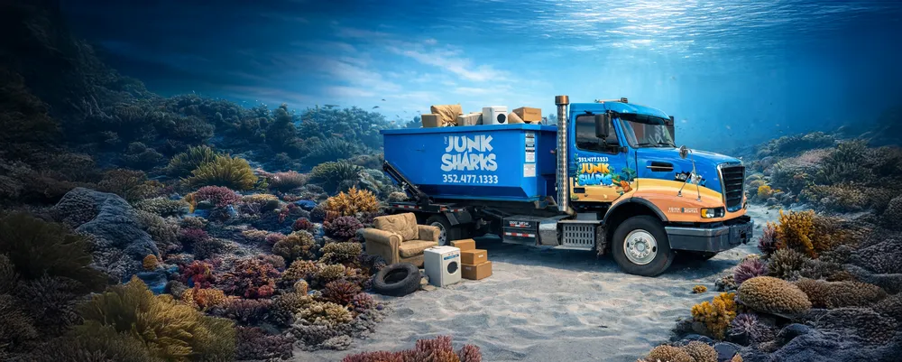 The Junk Sharks blue truck and dumpster hauling away furniture and appliances