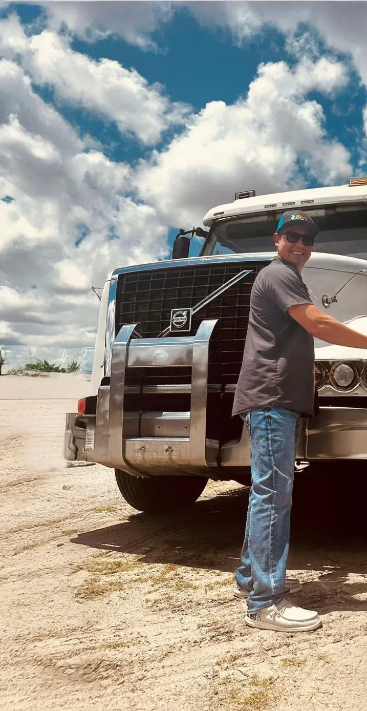 Owner Lance Mosher with a Junk Sharks roll-off truck in Ocala, Florida